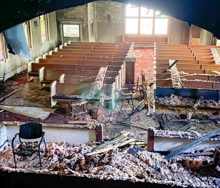 church, pews, debris all around the church after a fire